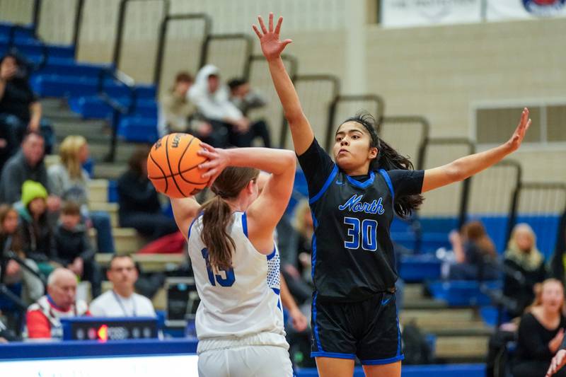 St. Charles North's Lelanie Posada (30) defends Geneva’s Linnea Popp (13) during a game at Geneva High School on Thursday, Dec. 4, 2025.