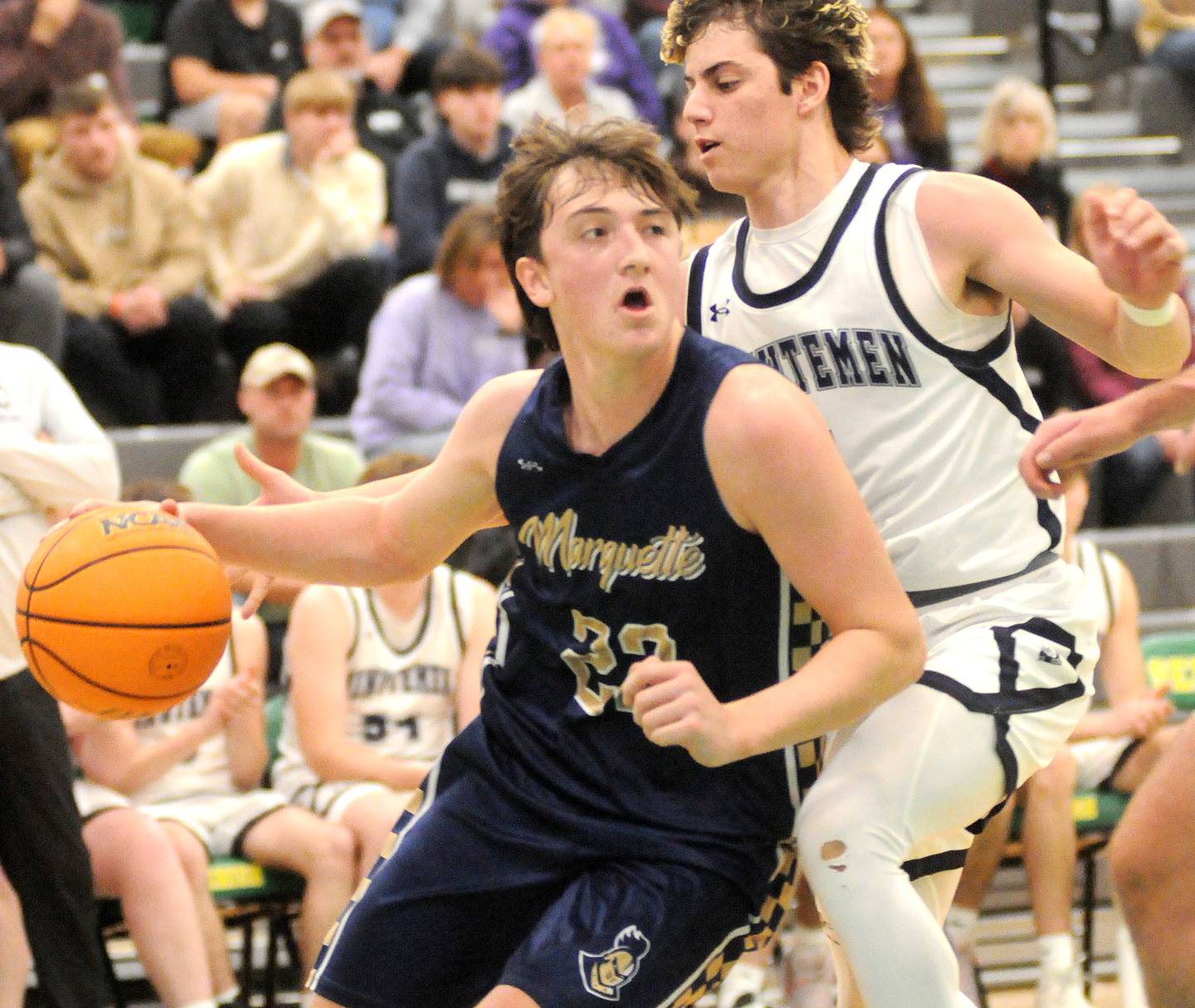 Marquette's Griffin Dobberstein (22) eyes the basket as Lexington's Blaine Friedmansky defends in the Shipyard Showdown semifinals on Friday, Dec. 26, 2025 in Seneca.