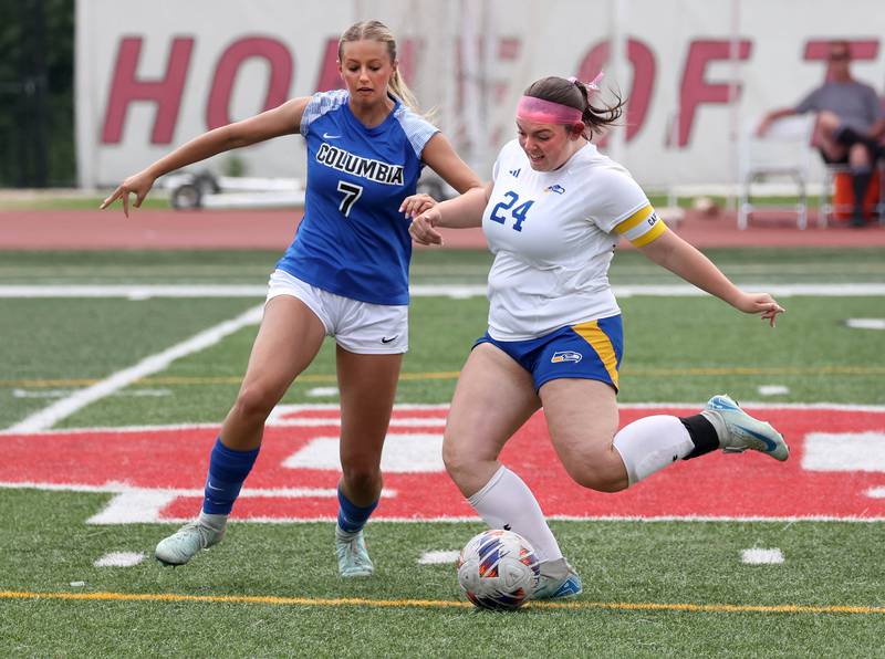 Johnsburg's Natalie Oeffling kicks the ball by Columbia's Avery Ellner Saturday, June 7, 2025, during the IHSA Class 1A state championship game at North Central College in Naperville.