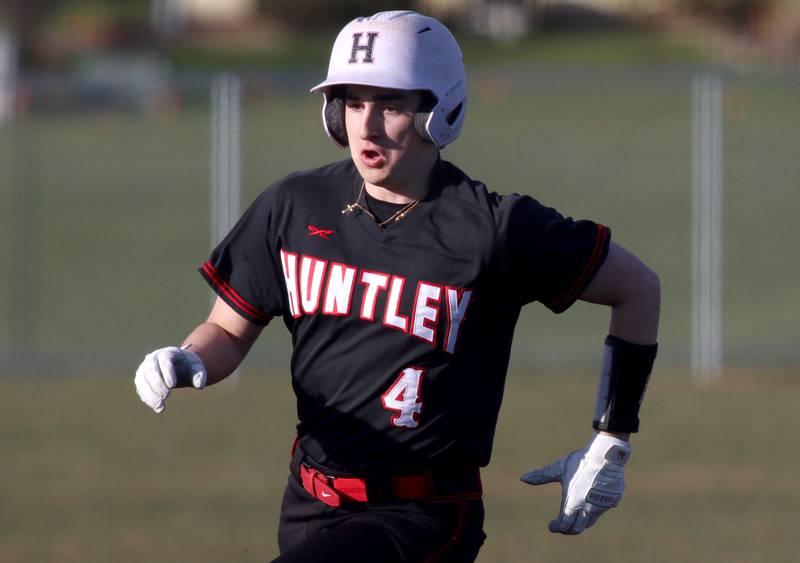 Huntley’s Ryan Dabe cruises toward third base in varsity baseball at McHenry Friday night.