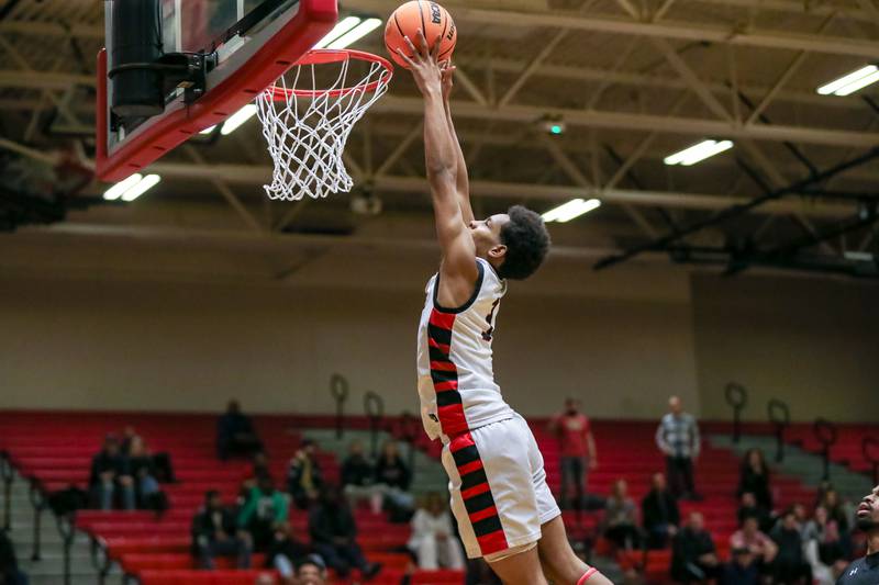 Bolingbrook's Davion Thompson (3) goes in for a dunk during their basketball game between Plainfield North at Bolingbrook, Friday Dec 13, 2024 in Bolingbrook.
