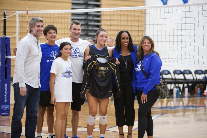 St. Charles North's  Hailey Burgdorf and family with  Head Coach Lindsey Hawkins presents her Under Armor All American jersey on Monday, Oct. 6, 2025 in St. Charles.