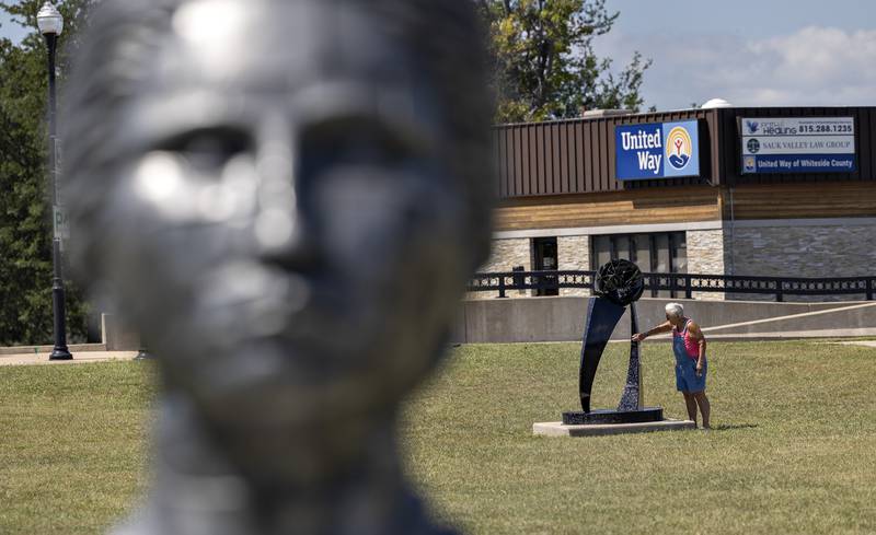 Mary Love of Sterling checks out the new sculpture “Altair” by Tim James and Aidan Demarais Saturday, August 23, 2025 at RB&W Park in Rock Falls.