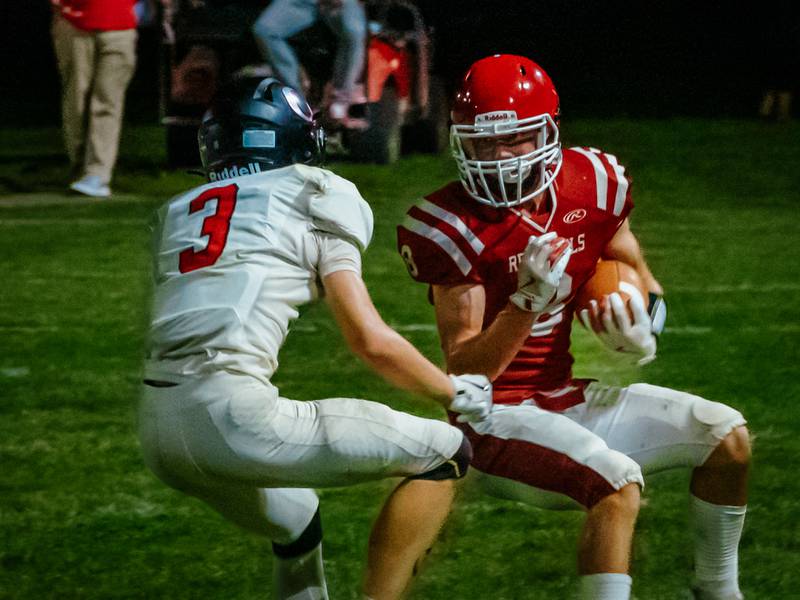 Braden Curran of Hall runs ball whilst being guarded by Jackson Peer of Orion on Friday, August 30, 2024 at Richard Nesti Stadium in Spring Valley.