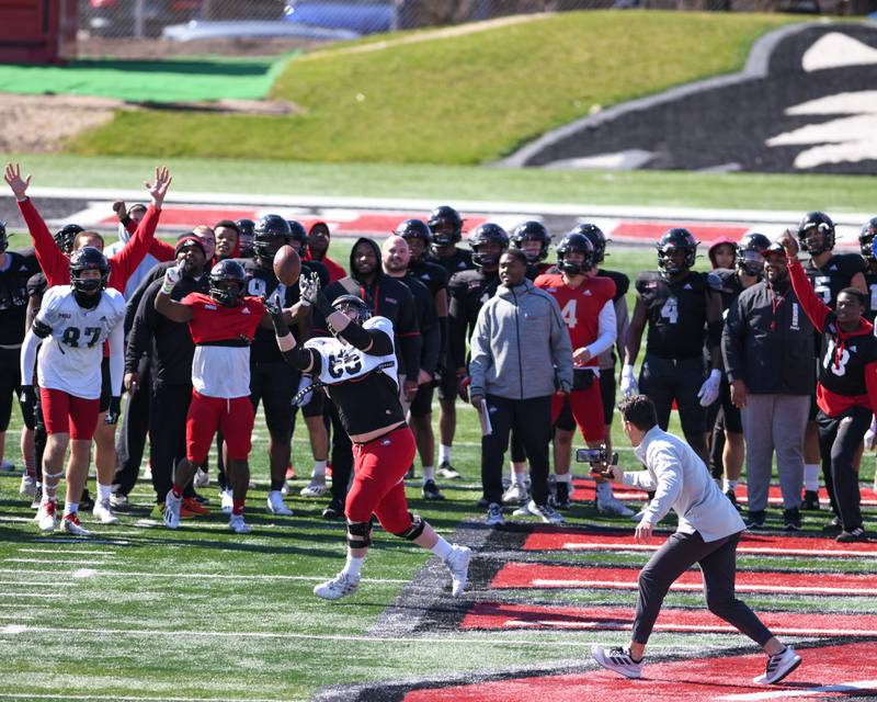Northern Illinois University offensive lineman Logan Zschernitz (65) catches the football at the start of the spring scrimmage held at Huskie stadium on Saturday April 16th in DeKalb.
