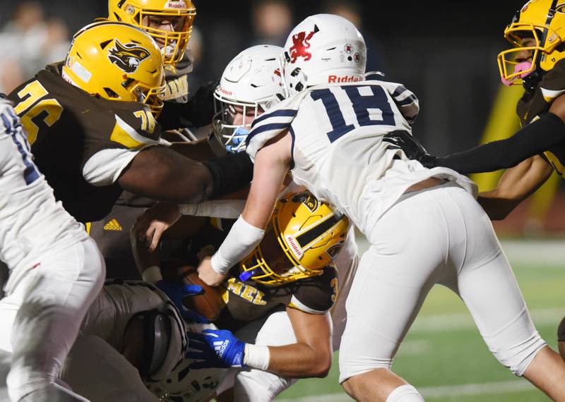 Joe Lewnard/jlewnard@dailyherald.com
Carmel’s Donovan Day (3) scores a touchdown as St. Viator players including Allistar Kanyuh (18) try to stop him during Friday’s game in Mundelein.