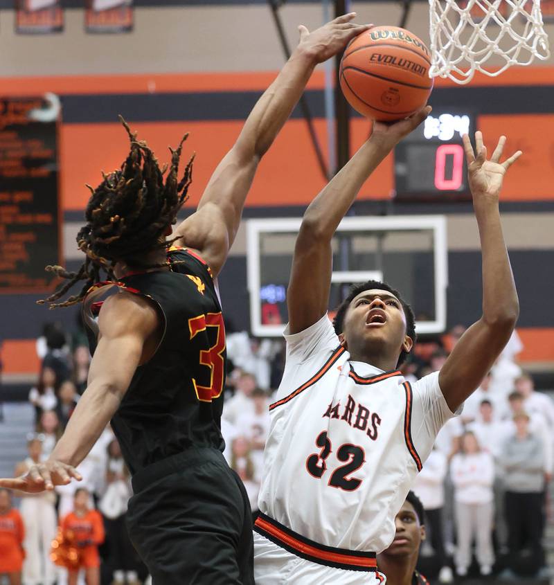 DeKalb’s Justin O’Neal goes to the basket against Jefferson's Cortez Christmas Wednesday, Feb. 21, 2024, during their Class 4A regional semifinal game at DeKalb High School.