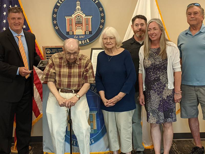 Kendall County Board Chairman Matt Kellogg, left, honored longtime historian Roger Matile, right, with the county's Citizen of the Year award during the May 21 Kendall County Board meeting.