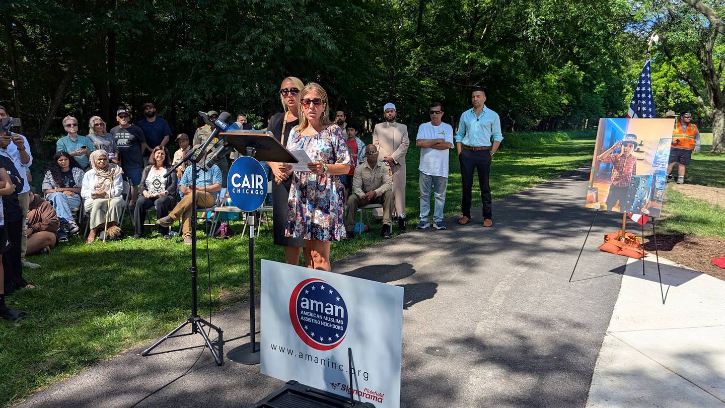 Will County Sheriff’s Office social workers Bonnie McPhilips (right) and Brittany Gruver (left) stood together while McPhillips read a prepared statement by Will County Sheriff Dan Jungles during the dedication of Wadee's monument on Saturday, June 28, 2025 at Van Horn Woods East Playground in Plainfield.