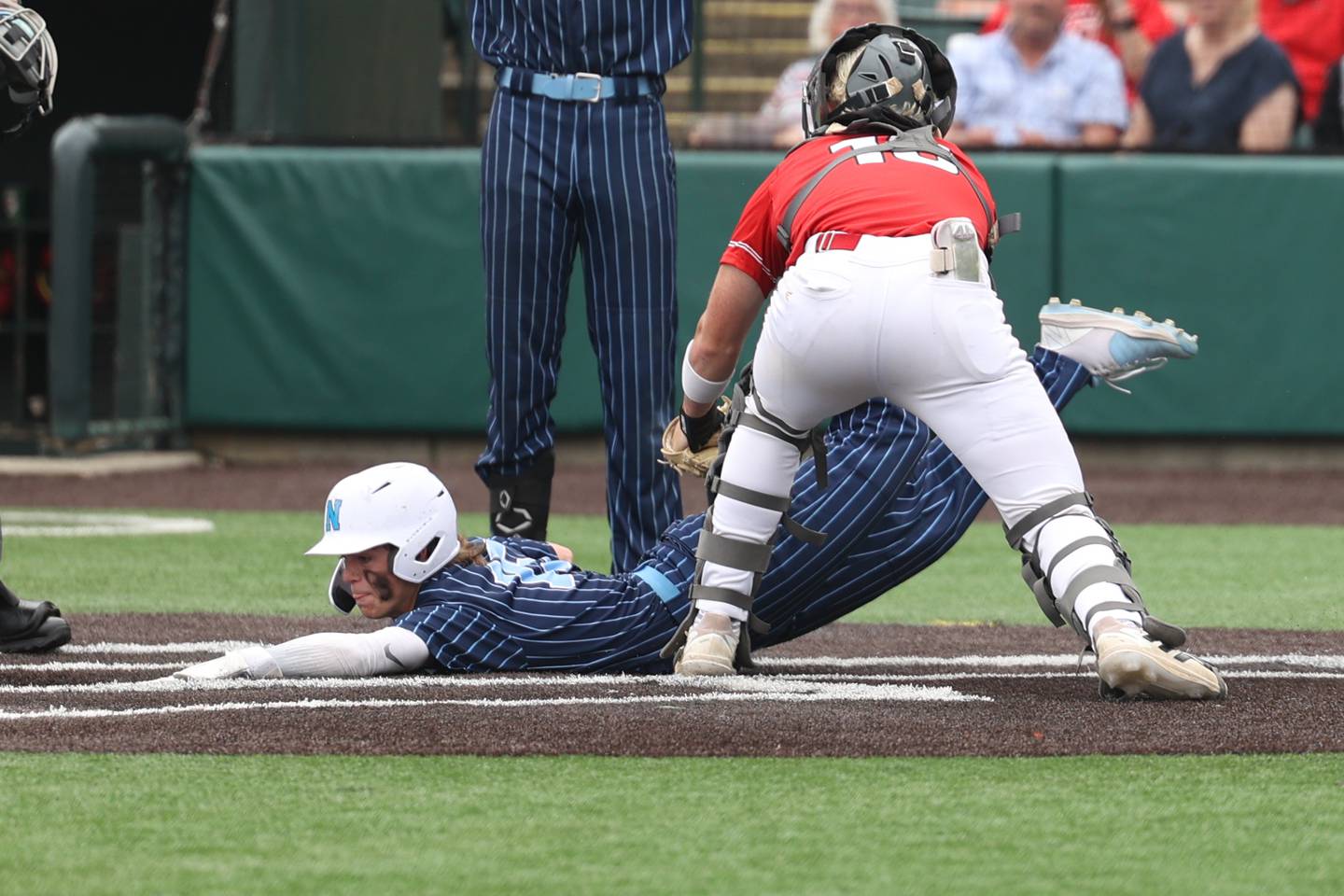 Nazareth’s Cole Reifsteck dives back to the plate to score against Glenwood in the IHSA Class 3A State championship. Saturday, June 11, 2022 in Joliet.