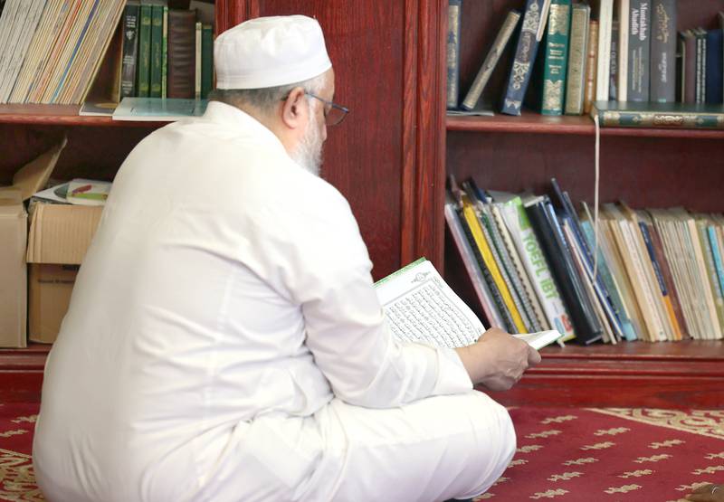 A man reads the Koran Friday, April 7, 2023, in the prayer hall, or musallā, at the Islamic Center of DeKalb. Muslims are currently observing the holy month of Ramadan.