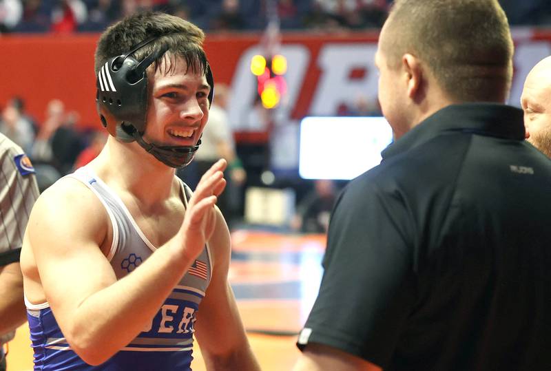 Princeton’s Augie Christiansen celebrates with his coach after his win in the Class 1A 145 pound 3rd place match Saturday, Feb. 18, 2023, in the IHSA individual state wrestling finals in the State Farm Center at the University of Illinois in Champaign.