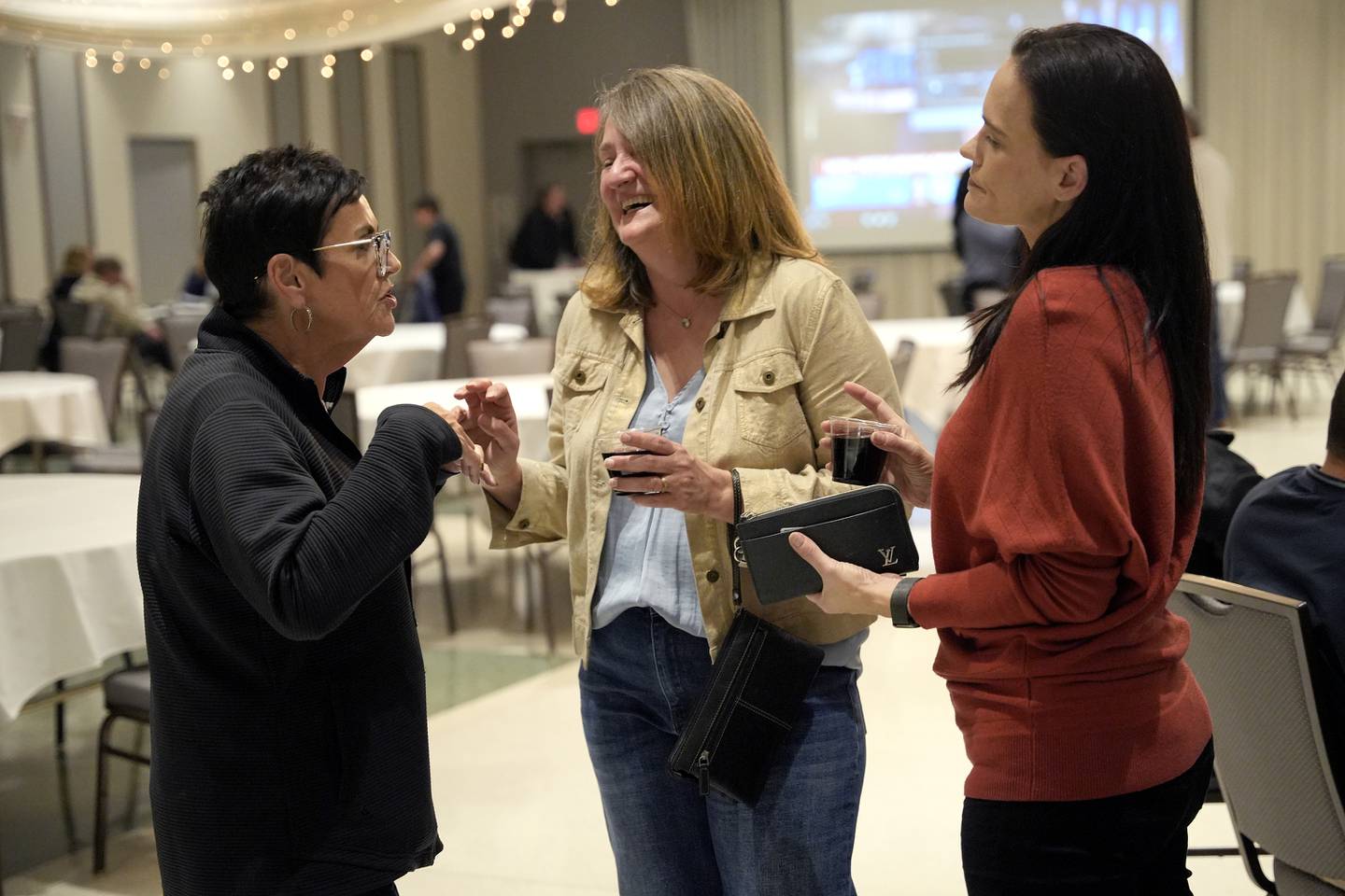 Deputy Majority Leader State Representative Natalie Manley, from left, Victoria Breslan, and Antoinette Granholm are seen at the Democratic watch party at IBEW Local 176 hall on Tuesday Nov. 5, 2024 in Joliet, Ill.
