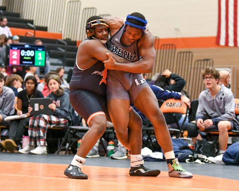DeKalb’s Lamar Bradley, left, takes down and pins Mathias Ewuoso of Lake Park in the 215 weight class on Saturday Nov. 22, 2023, during the quad meet held at DeKalb High School.