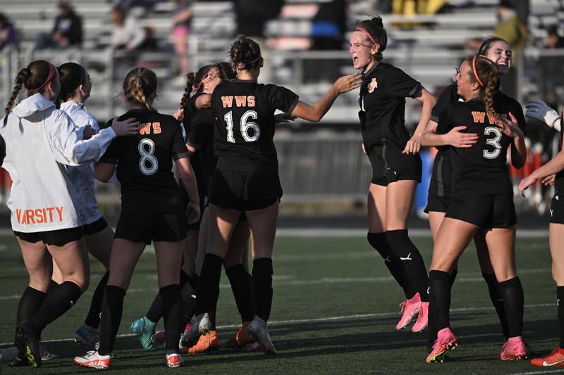 Wheaton Warrenville South’s Ashlyn Adams jumps and yells as teammates celebrate a win against St. Charles North in a girls soccer game in Wheaton on Tuesday, April 16, 2024.