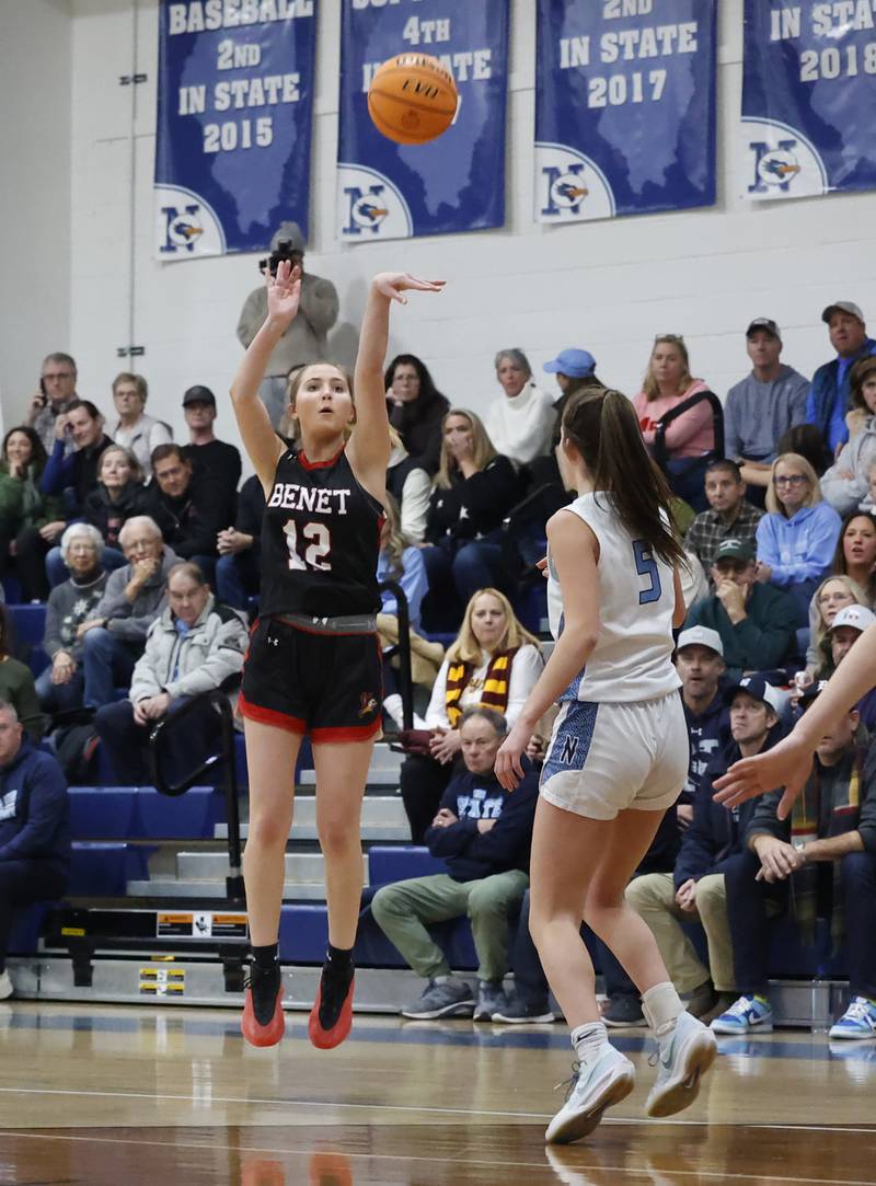 Benet's Lindsay Harzich (12) takes a three-point shot during a girls varsity basketball game between Benet and Nazareth academies on Saturday, Dec. 14, 2024 in La Grange Park.
