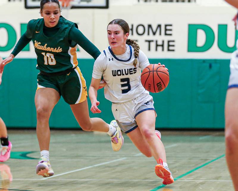 Oswego East's Maggie Lewandowski (3) drives down the lane at the York Thanksgiving Tournament. Nov 13, 2023.
