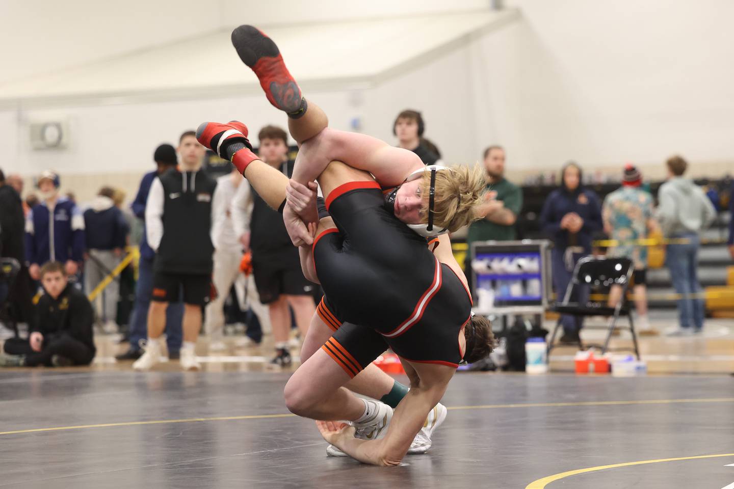 Minooka’s Kaden Meyer drops Bolingbrook’s Tommy McDermott in the 165-pound weight SPC Conference championship match at Joliet West on Saturday, Jan 25, 2025.