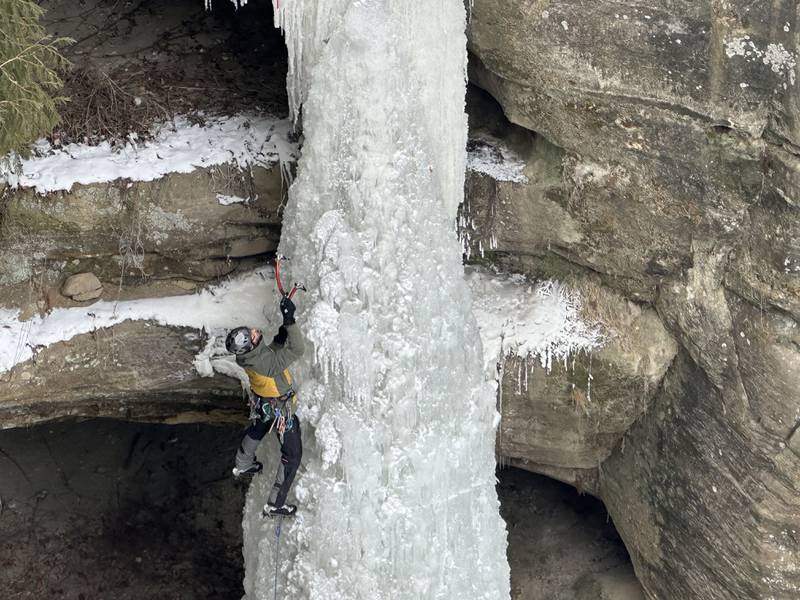 An ice climber climbs up a 90-foot tall frozen waterfall on Sunday, Jan. 21, 2024 in Starved Rock State Park.