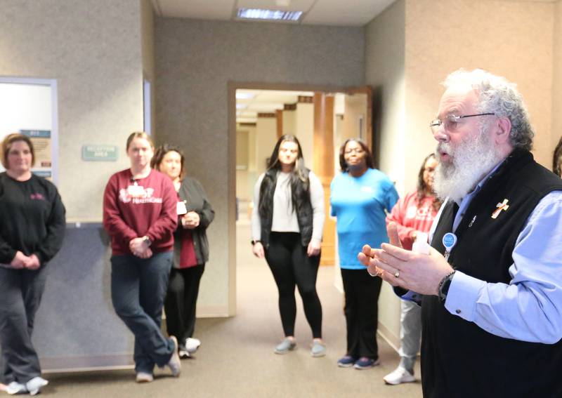 Decan George Schramm blesses the hands of healthcare workers at the new OSF Healthcare clinic on Wednesday, Jan. 10, 2024 in Spring Valley. The clinic is located across from the former St. Margaret's Hospital at the intersection of East First and Mary Streets in Spring Valley.