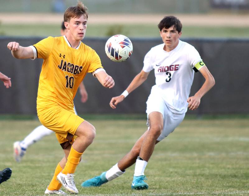 Jacobs’  Jackson Foley, left, and Prairie Ridge’s Trenton Pavoris follow the ball in varsity soccer at Jacobs High School in Algonquin on Thursday, Sept. 18, 2025.