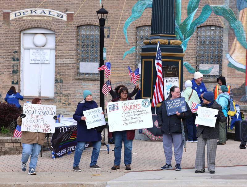 Protesters gather Friday, May 1, 2026, during a May Day rally at Memorial Park in downtown DeKalb.