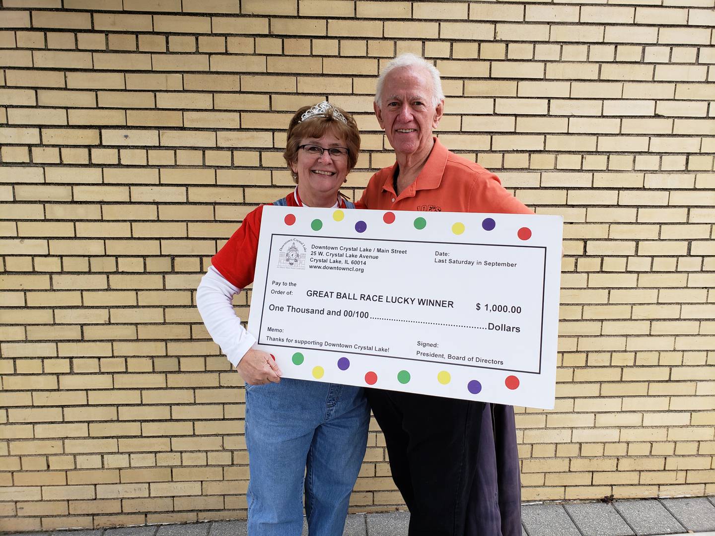 Diana Kenney presents Jack McArdle, winner of the Great Ball Race, with a check in September 2019.