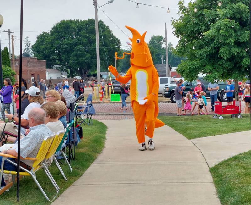 A shrimp mascot walks the festival grounds and waves to attendees Saturday, June 1, 2024, at Rotary Park during the ShrimpFest and Brew Hullaballoo in Princeton.
