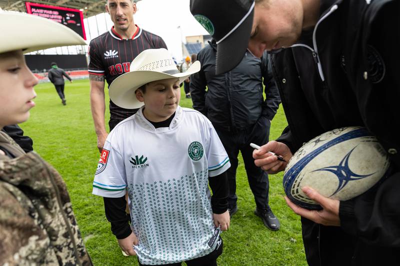 Chicago Hounds fan Maverick Majchrzak, looks on as Chicago Hounds’ player Caleb Strum signs his rugby ball after a match at Seat Geek Stadium in Bridgeview, on Sunday April 23, 2023. Strum commented how he remembered what it was like as a kid meeting players and is honored to be in those shoes now.