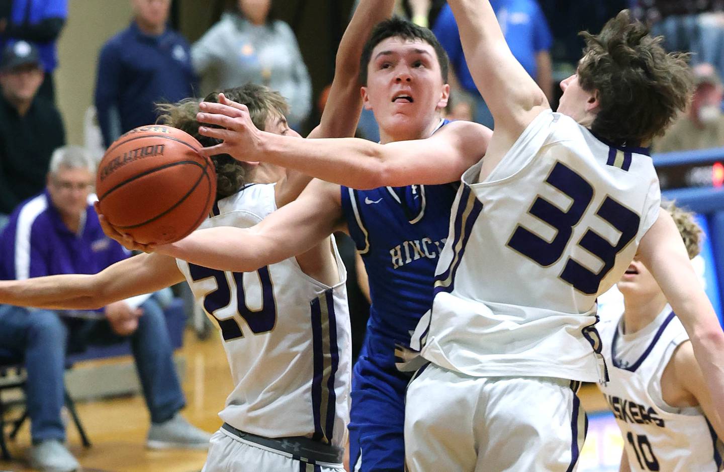 Hinckley-Big Rock's Ben Hintzsche goes to the basket between Serena's Bradley Armour (left) and Hunter Staton Friday, Feb. 3, 2023, during the championship game of the Little 10 Conference Basketball Tournament at Somonauk High School.