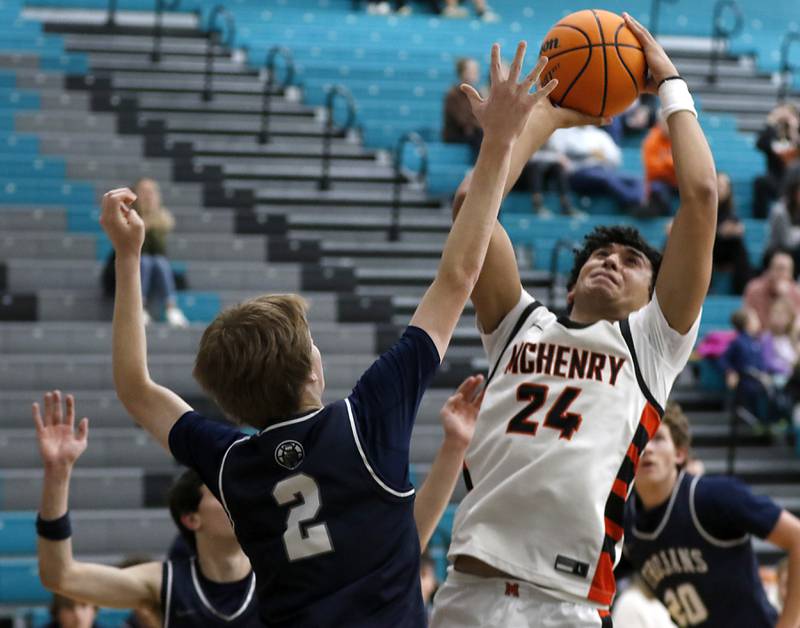 McHenry's Adam Anwar shoots the ball over Cary-Grove's AJ Berndt during the Woodstock Hoops for Healing Tournament Championship game on Wednesday, Nov. 27, 2024, at Woodstock North High School.