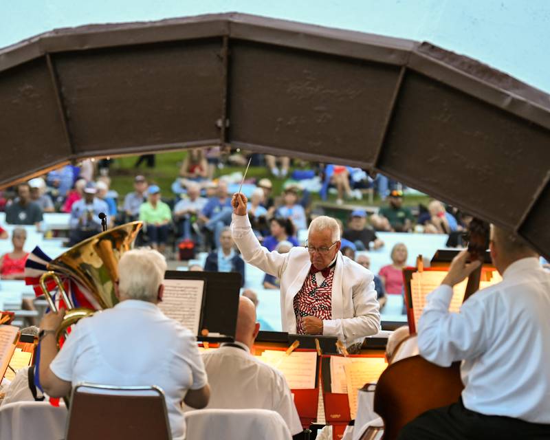 Kirk Lundbeck conducts the DeKalb Municipal Band as they perform during the Independence Day concern on Monday July 4, 2022 in Hopkins Park in DeKalb to celebrate the Fourth of July.