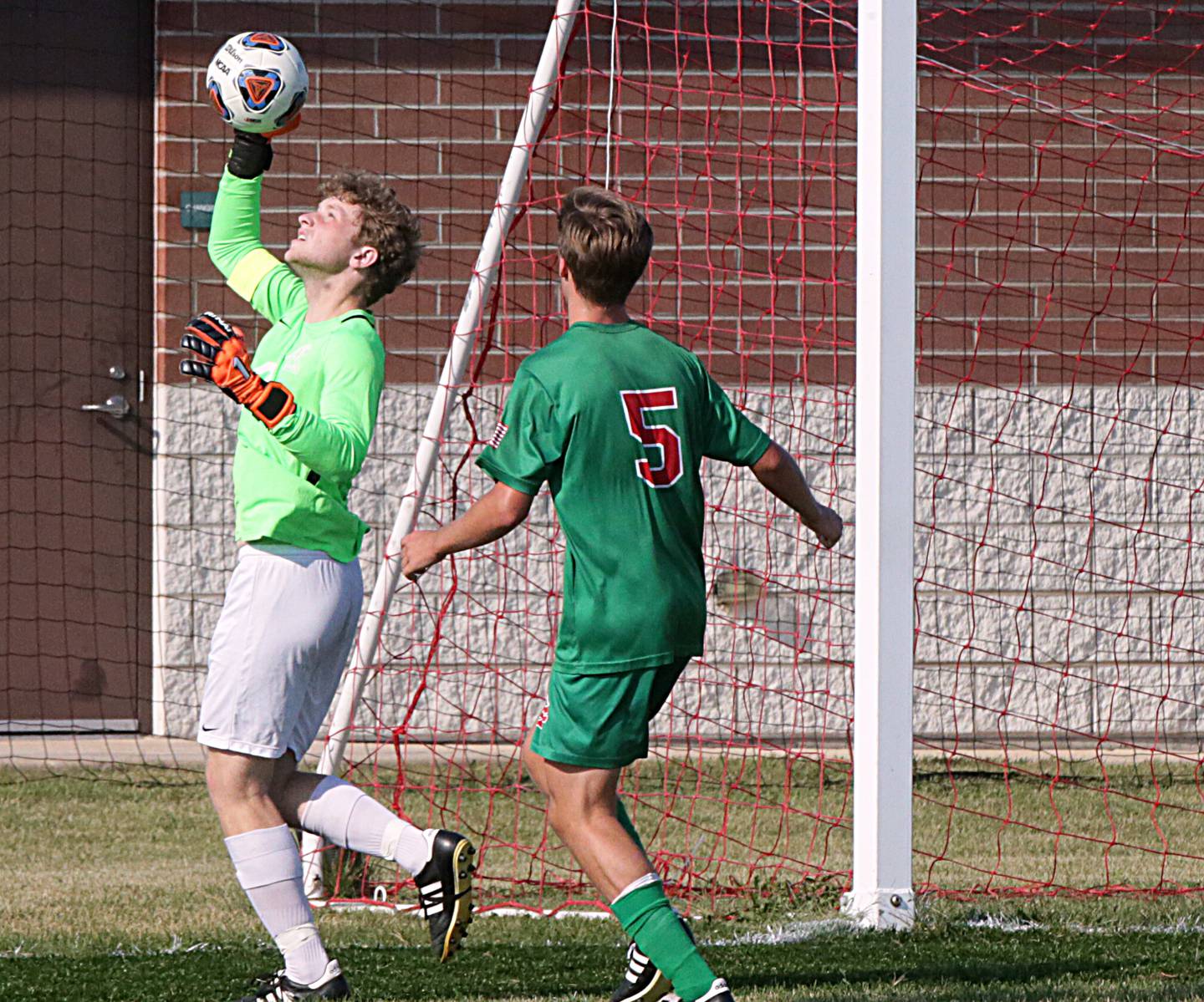 Kaneland goalkeeper Andrew Davison blocks a shot from L-P's Seth Adams (no,5) by the net on Monday Aug. 30, 2021.