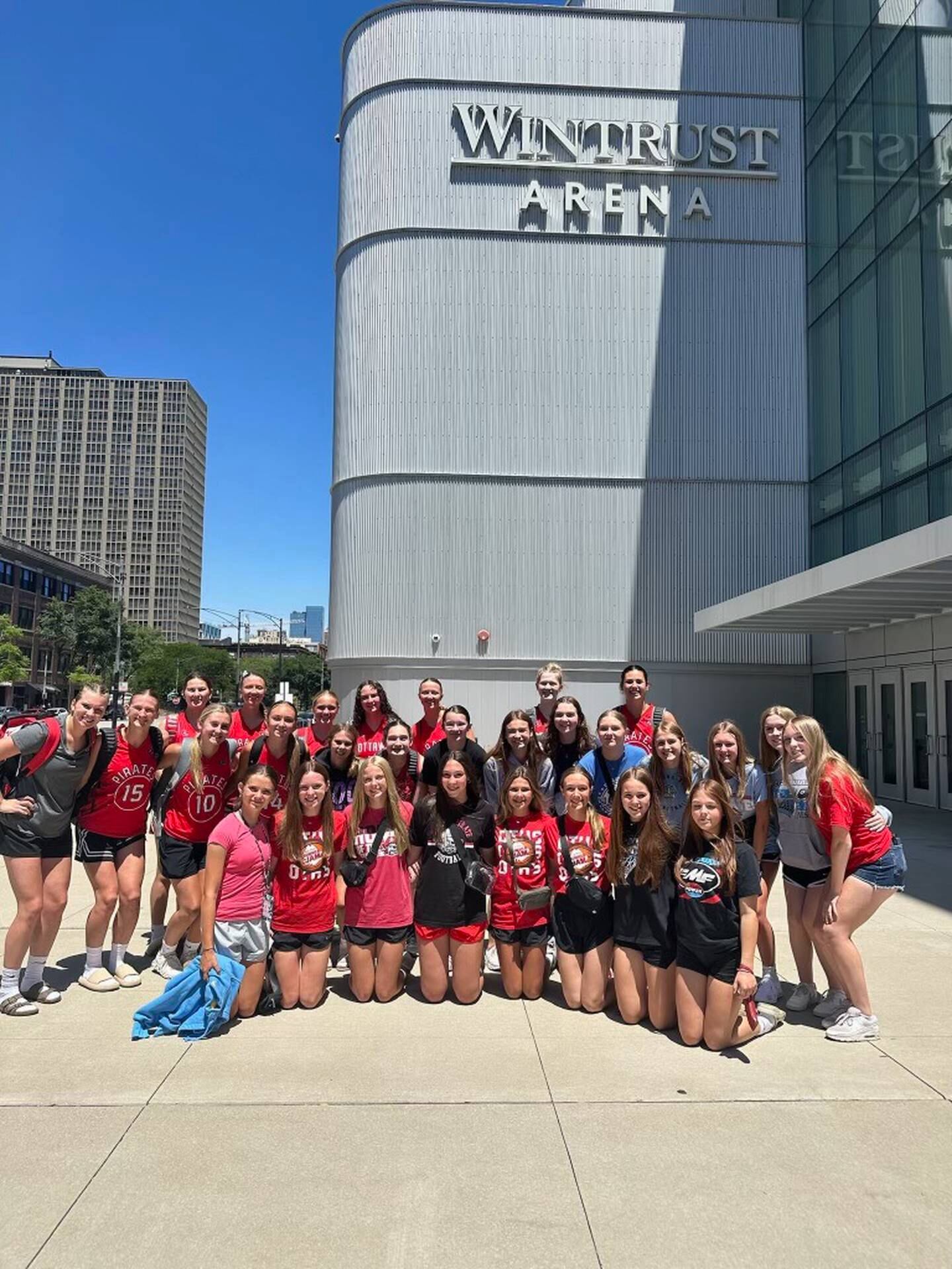 The Ottawa girls basketball team poses outside Wintrust Arena, home of the WNBA's Chicago Sky, on Wednesday, June 12, 2024, in Chicago.