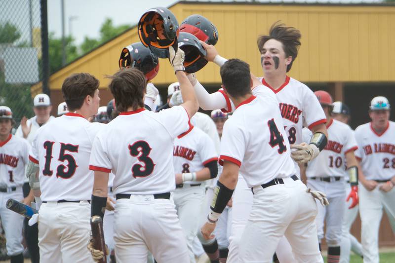 Huntley's AJ Putty (18) is greeted at home plate after hitting a home run against McHenry at the Class 4A Sectional Final on June 4, 2022 in Algonquin.