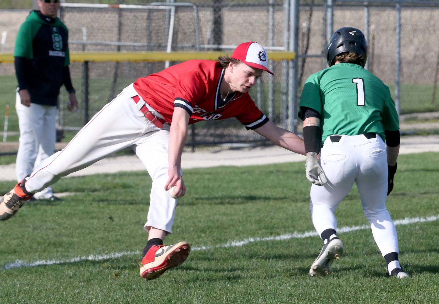 Streator's Clay Christoff tags out Seneca's Nathan Neal while rounding third base on Friday, April 19, 2024 at Seneca High School.