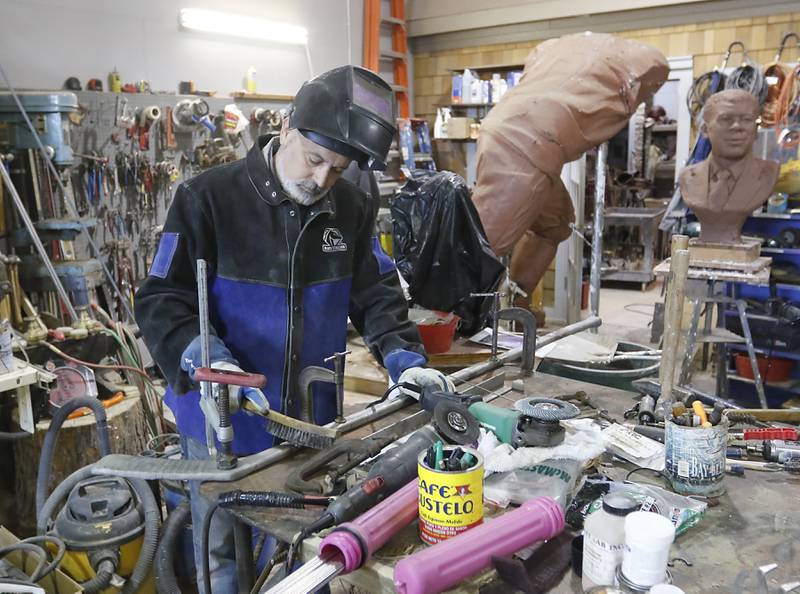 Erik Blome works on a sculpture in his studio in Woodstock on  Dec. 27, 2022.