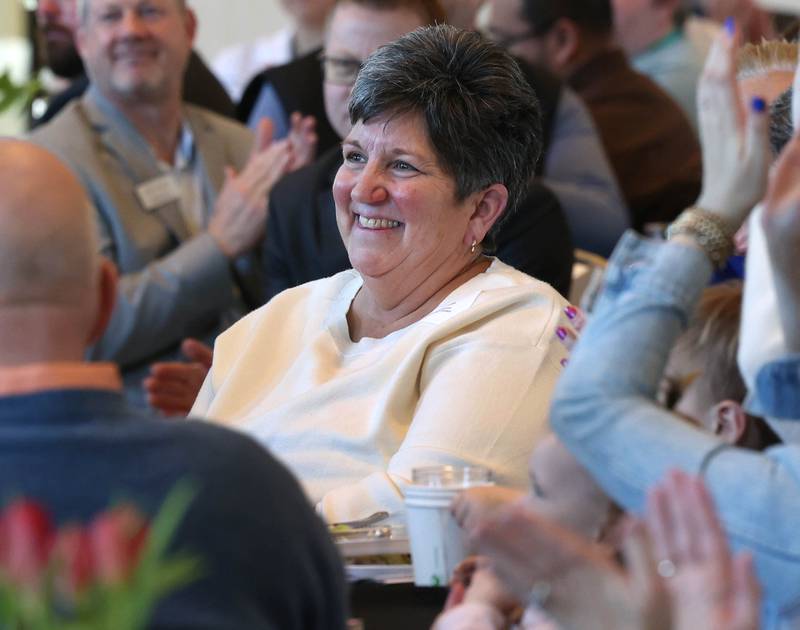 Kris Wrenn, who owned and operated Kar-Fre Flowers along with her sister Michelle Schulz (not pictured), smiles as she and her sister are introduced as the winners of the Clifford Danielson Outstanding Citizen Award during the Sycamore Chamber of Commerce Annual Meeting Thursday, March 6, 2025, at St. Mary's Catholic Church in Sycamore.