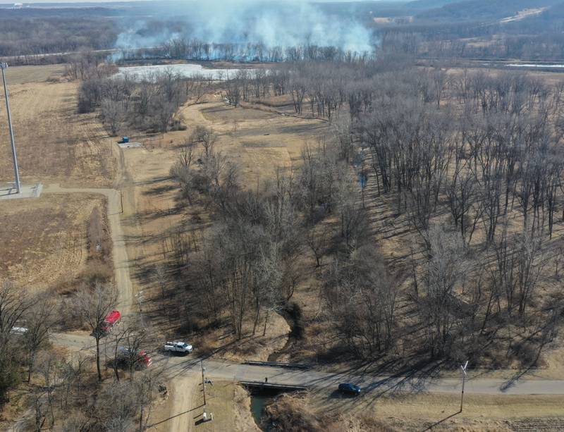 Firefighters gather on the scene of a large brush fire near Interstate 180, which intersects with the Hennepin Canal on Tuesday, Feb. 10, 2026 near Princeton. A Mutual Aid Box Alarm (MABAS) was dispatched around 12:30p.m. Bureau County Fire departments from Bureau, Ladd, Wyanet, Princeton, Hennepin and others assisted with the brush fire.