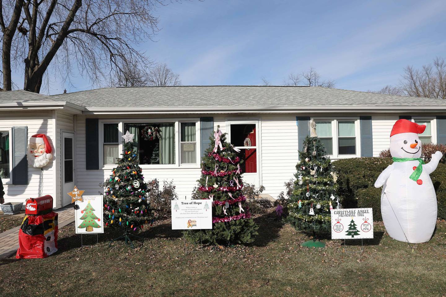 Three Christmas trees sit in the front yard Sam Chellino, where people can hang ornaments in memory of lost loved one, those effected by cancer or simply making a holiday wish on Friday, Dec. 13, 2024 in Joliet.