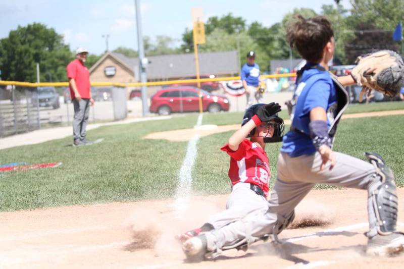 Bi-County's McCoy Biagini comes home on a passed ball in District 20 Tournament play.