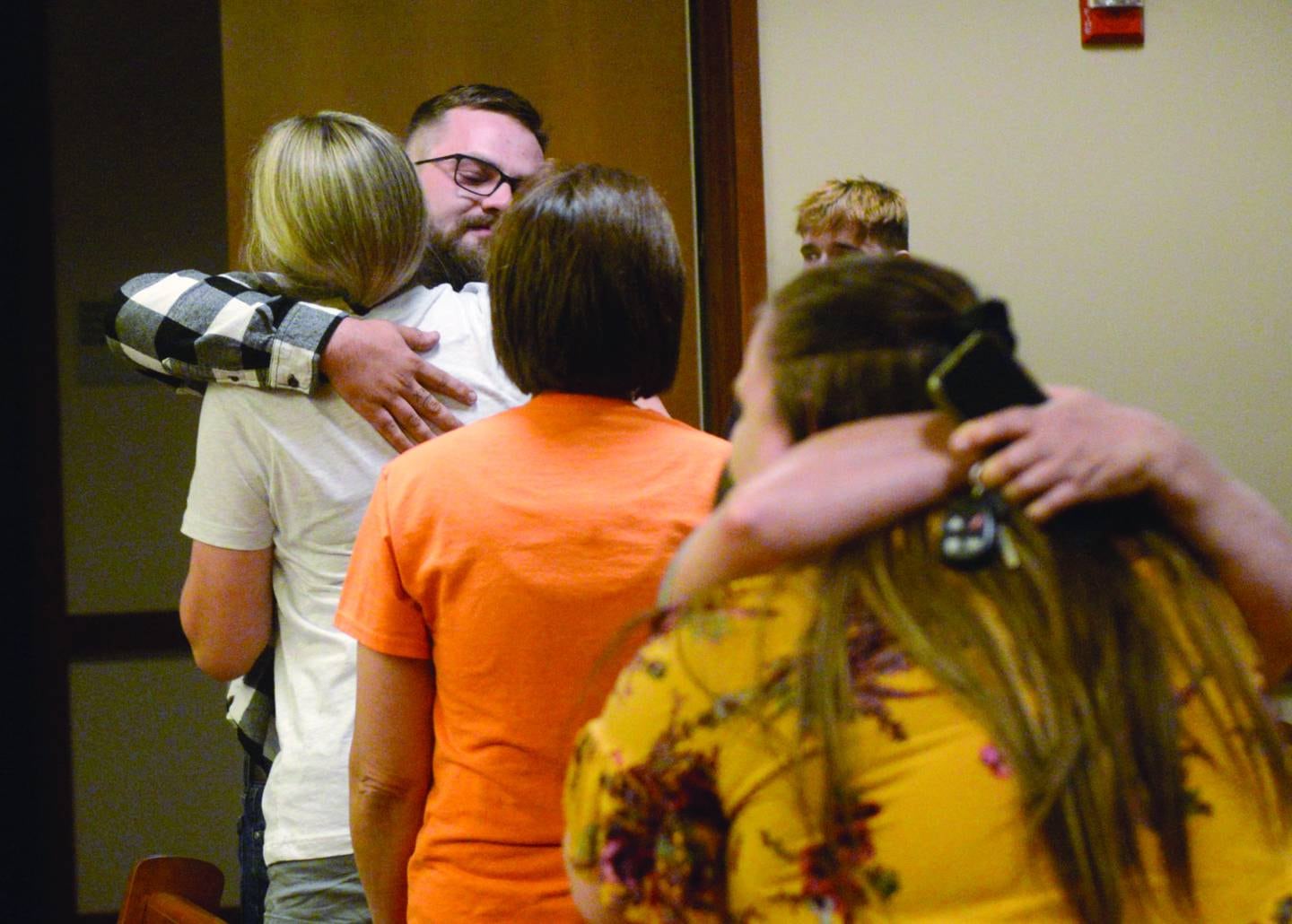 Cody Neuschwanger hugs family and friends on Thursday, May 11, 2023 as other family members embrace after he was found not guilty of first degree murder following a 2-day bench trial at the Ogle County Judicial Center in Oregon.