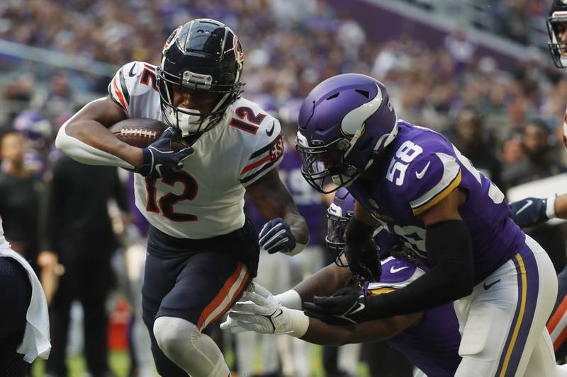 Chicago Bears wide receiver Velus Jones Jr. scores on a 9-yard touchdown reception ahead of Minnesota Vikings linebacker Jordan Hicks during the second half, Sunday, Oct. 9, 2022, in Minneapolis.