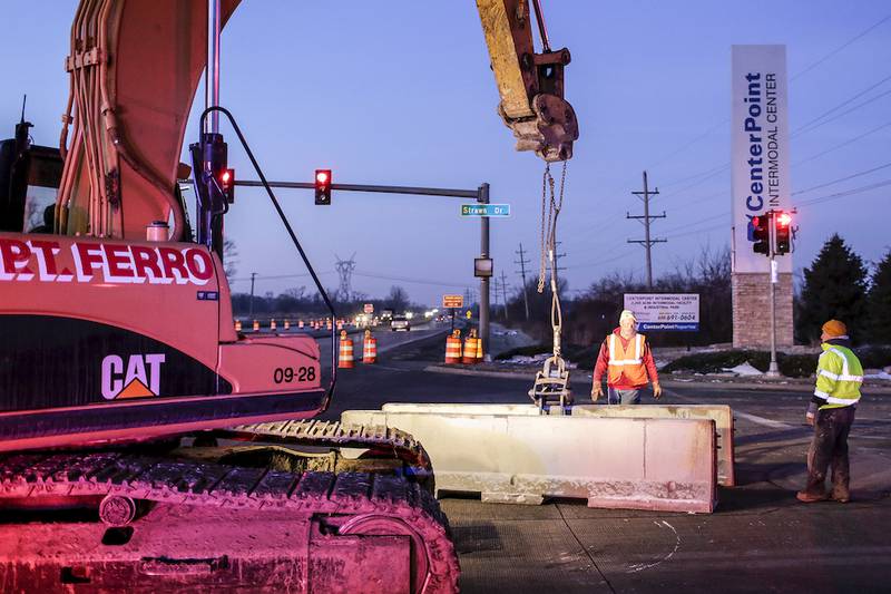 A crew works Jan. 28 to close off access to the Walter Strawn Drive railroad crossing from State Route 53 in Elwood. The closing has led the city of Joliet to consider charging for overweight permits if a survey shows a disproportionate number of trucks are being diverted to Joliet due to the closing.