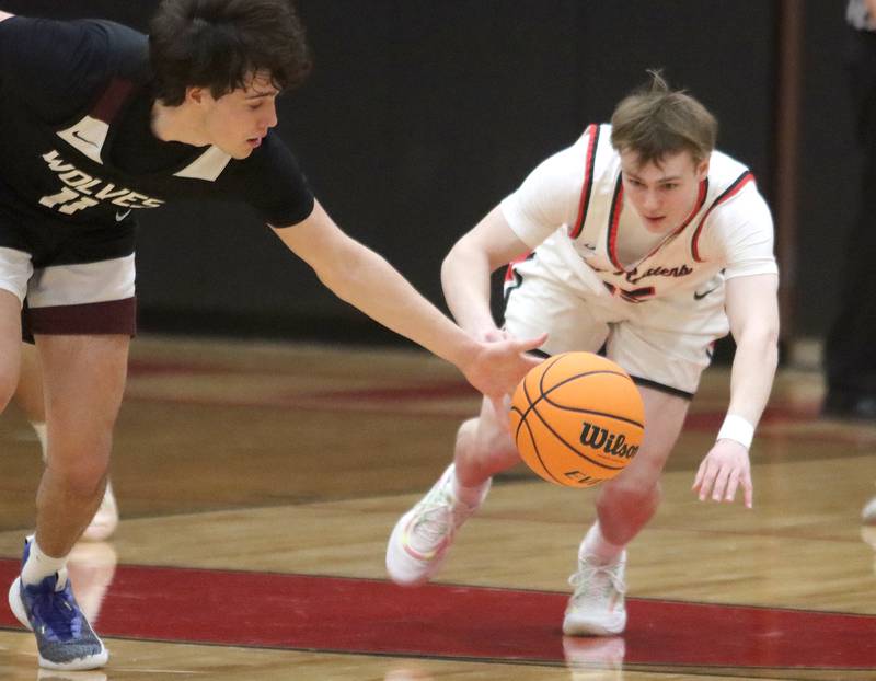 Prairie Ridge’s Ben Gablenz, left, tips the ball away from Huntley’s Aidan Gibbs in varsity boys basketball on Tuesday, Feb. 18, 2025, at  Huntley High School in Huntley.