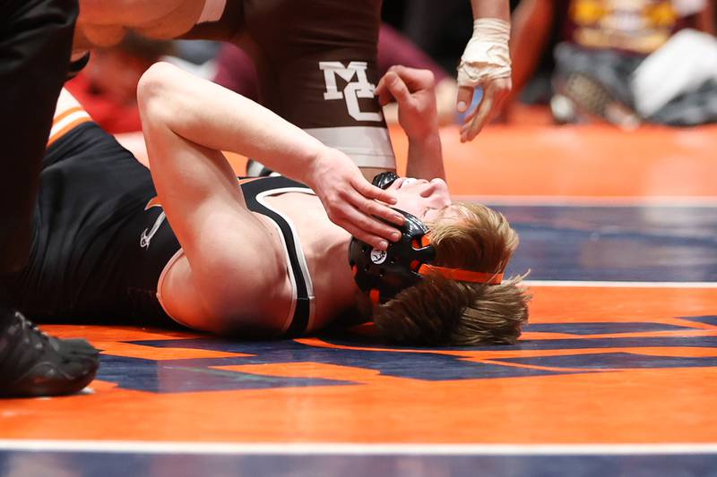 DeKalb’s Austin Martin lays on the mat after a loss to Sergio Lemley in the 138 pound match that gave Mount Carmel the Class 3A dual team championship  at Grossinger Motor Arena in Bloomington. Saturday, Feb. 26, 2022, in Champaign.