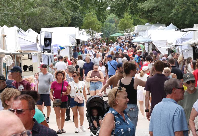 Hundreds of visitors walk through the tents Saturday, July 26, 2025, during the Geneva Arts Fair on Third Street in Geneva.
