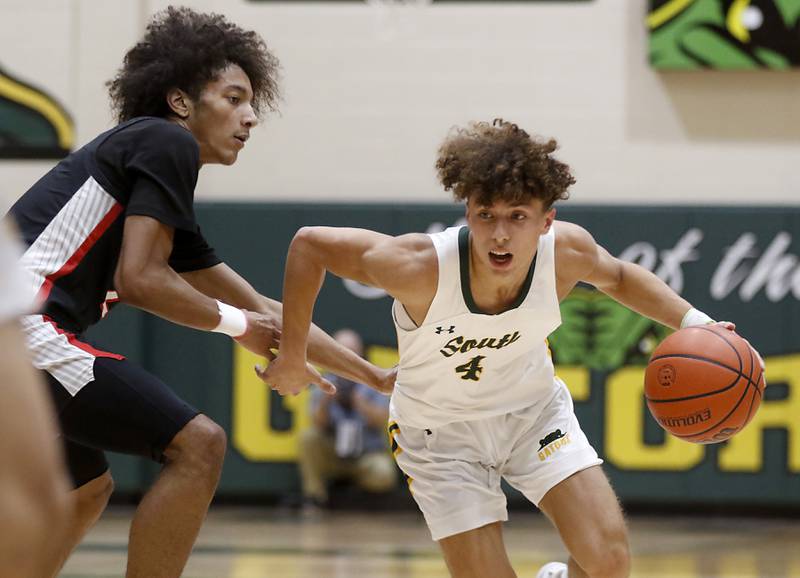 Crystal Lake South's AJ Demirov tries to drive to the basket against \Huntley's Omare Segarra during a Fox Valley Conference boys basketball game on Wednesday, Dec. 13, 2023, at Crystal Lake South High School.