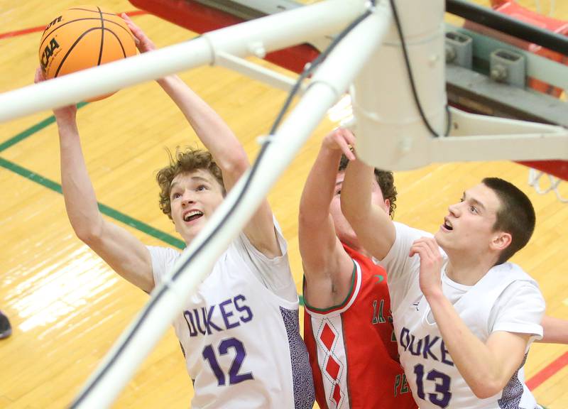 Dixon's Gabe Rowley grabs a rebound with the help of teammate Cullen Shaner over L-P's Mikey Hartman during the Class 3A Regional semifinal game on Wednesday, Feb. 26, 2025 in Sellett Gymnasium at L-P High School.