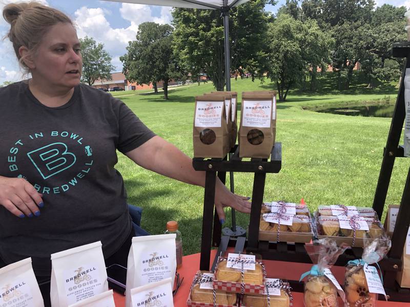 Lisa Shade shows off dog treats for sale at Pawfest in Huntley Aug. 3, 2024.